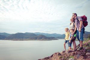 46976082 - happy family standing near the lake at the day time. concept of friendly family.