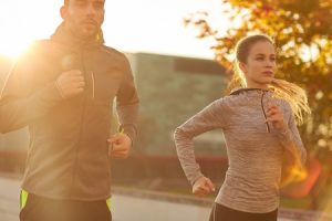 51225209 - fitness, sport, people and lifestyle concept - couple running outdoors