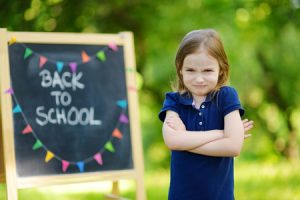 41378658 - adorable little schoolgirl feeling unhappy about going back to school