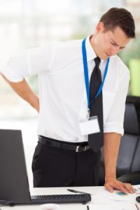 22538046 - businessman having lower back pain in office